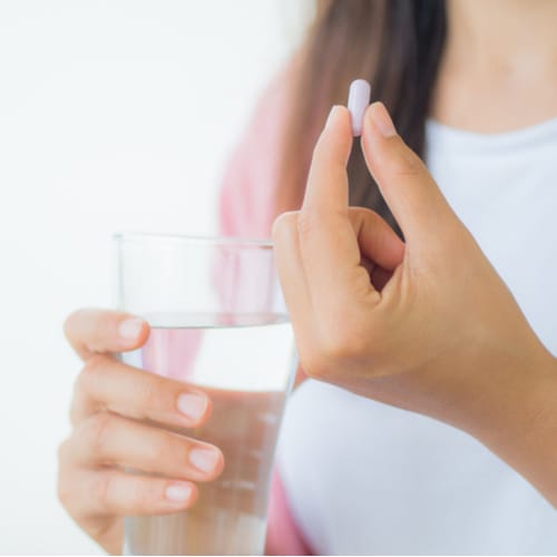 woman taking pill