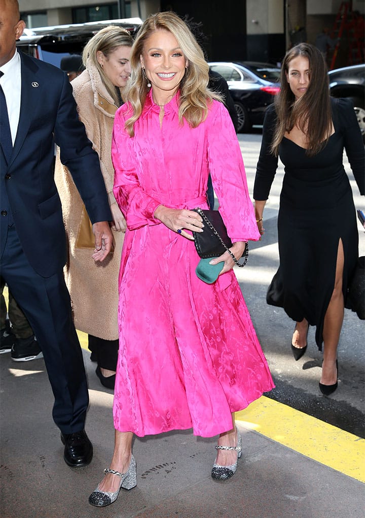 Kelly Ripa entering the Power of Women event in a megenta pink dress