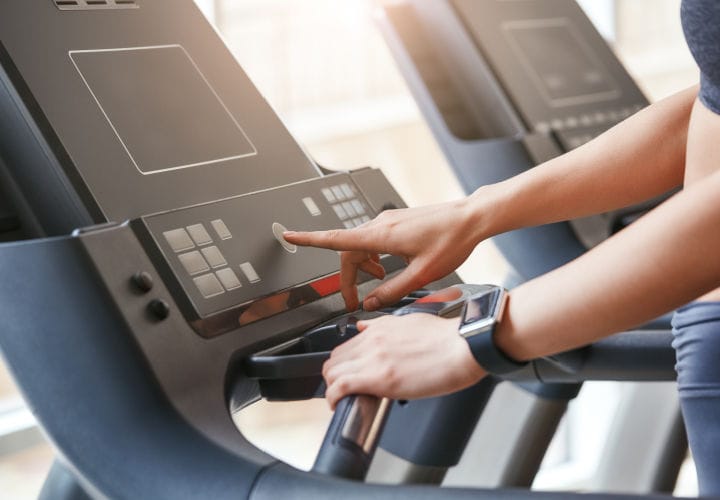 Person increasing incline on a treadmill