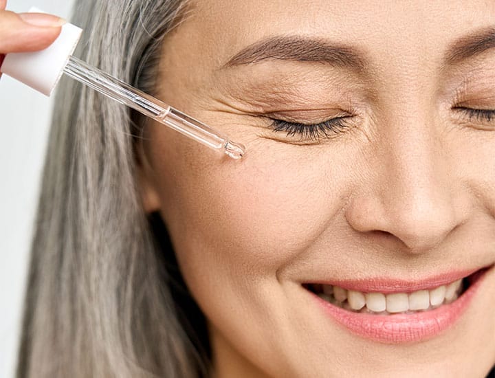 woman-using-skincare-serum