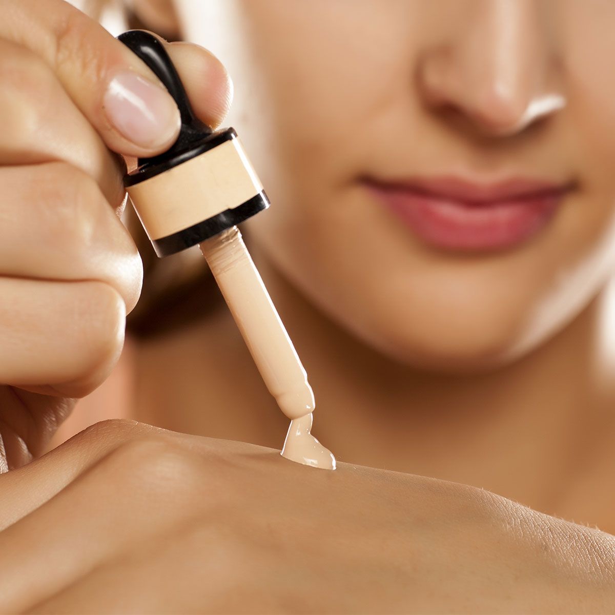 woman-dispensing-liquid-foundation