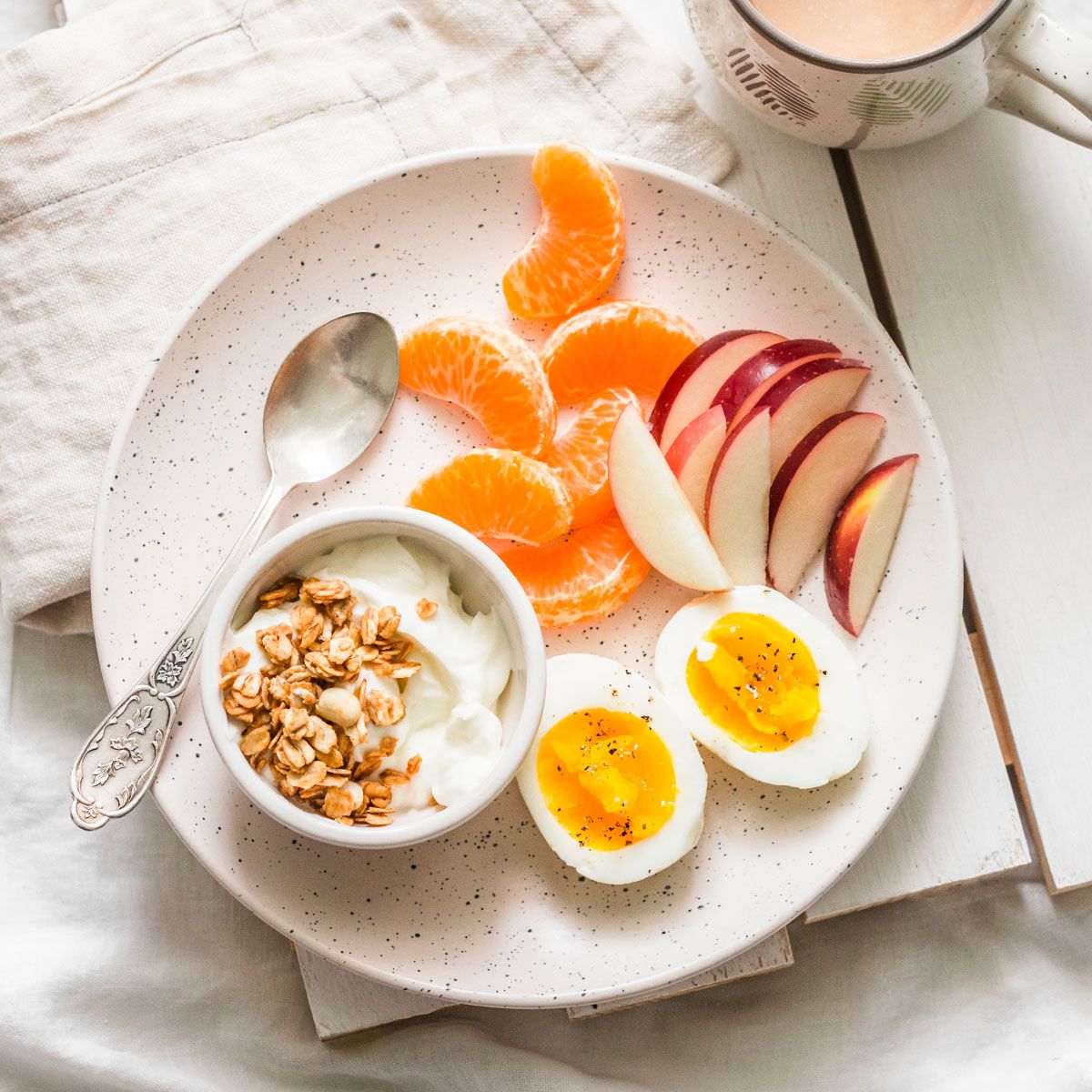 breakfast platter with eggs, yogurt, and fruit