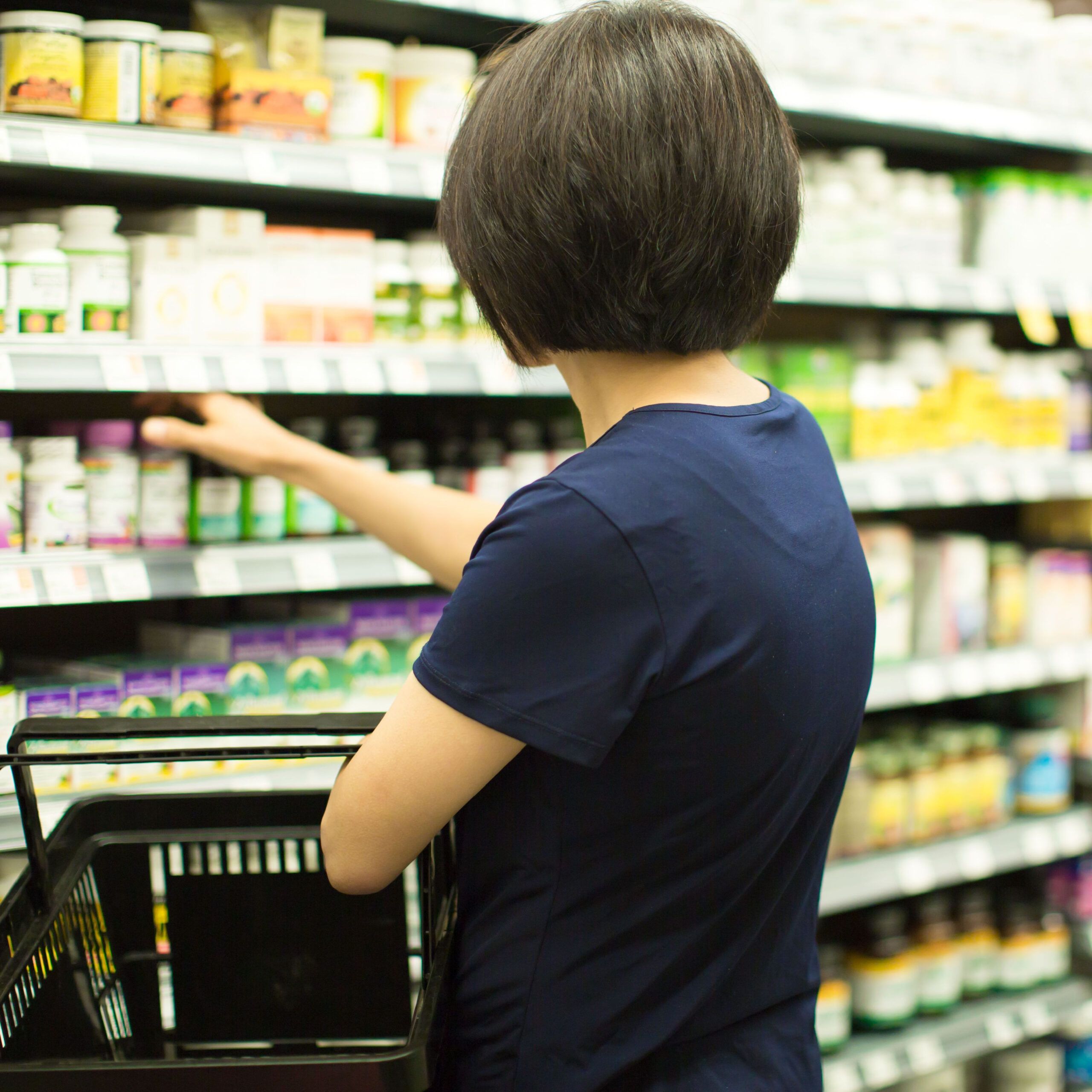 woman browsing supplement aisle