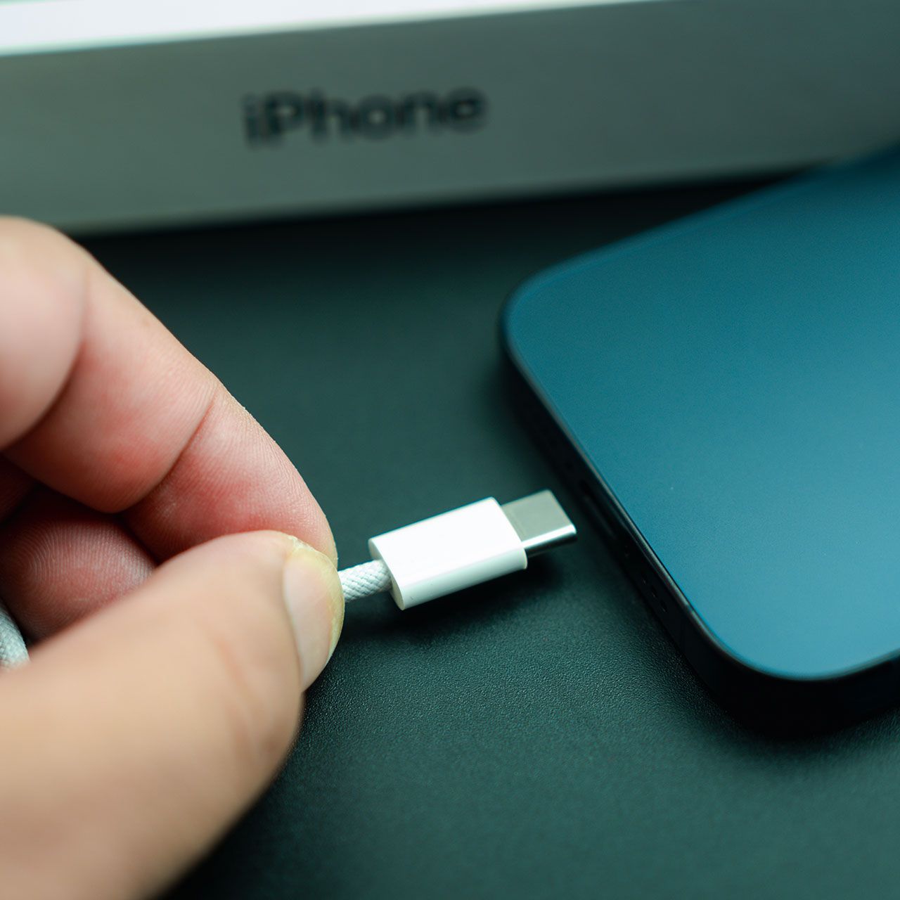 plugging-in-blue-iphone