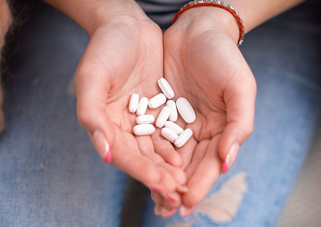 calcium pills in a woman's hands