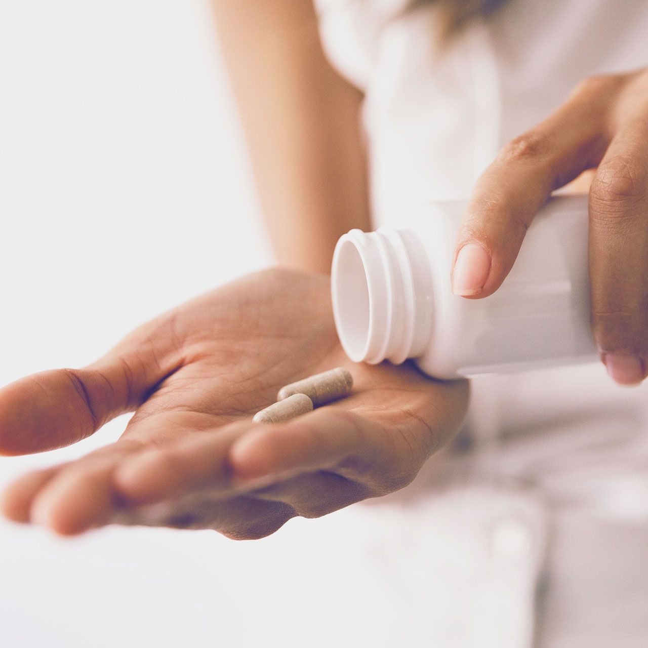 woman taking supplements in morning