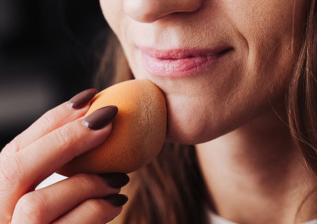 woman-damp-makeup-sponge