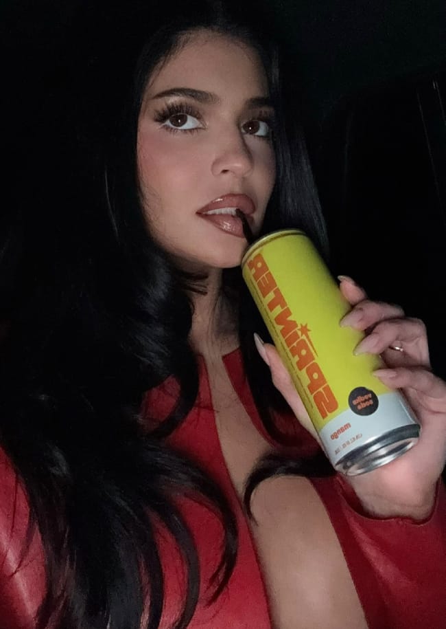 Kylie Jenner red jacket selfie with drink