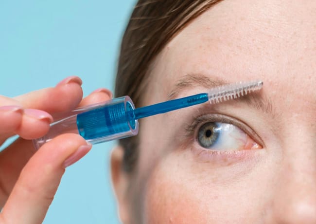 woman-brushing-eyebrows