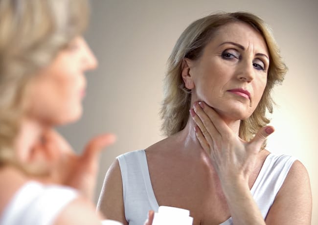 woman-putting-moisturizer-neck