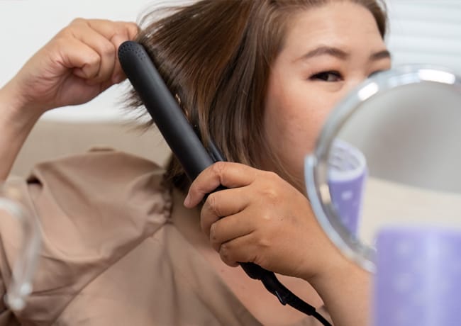 woman-flat-ironing-hair
