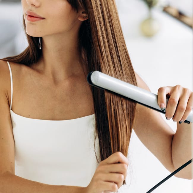woman-straightening-hair