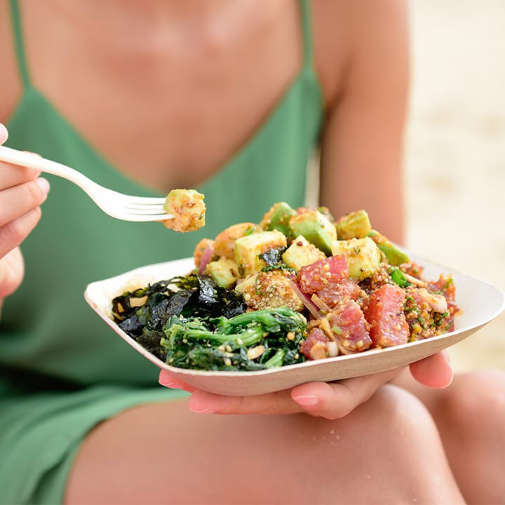 woman eating poke bowl