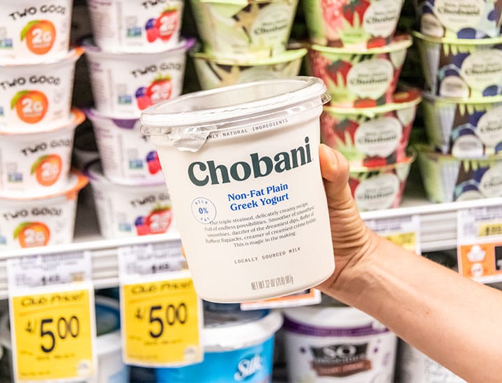 Person holding a cart of Chobani Greek yogurt