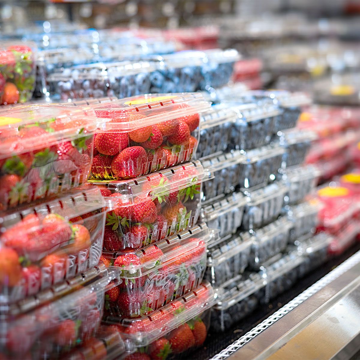 strawberries and blueberries at grocery store