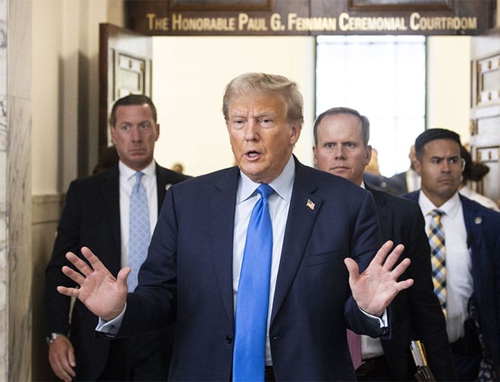 Donald Trump talks to reporters during courtroom break