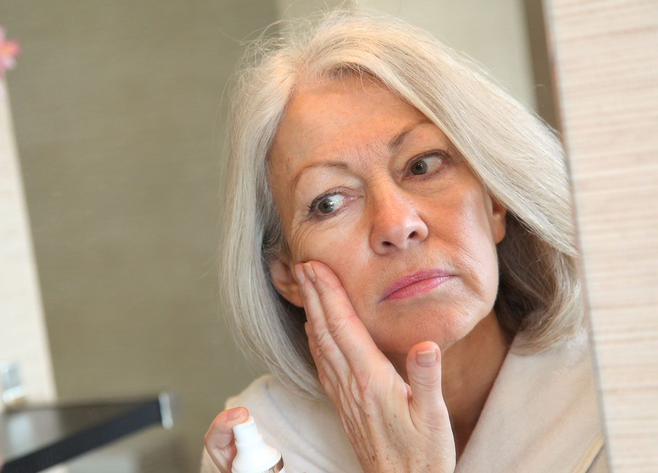 mature-woman-applying-makeup