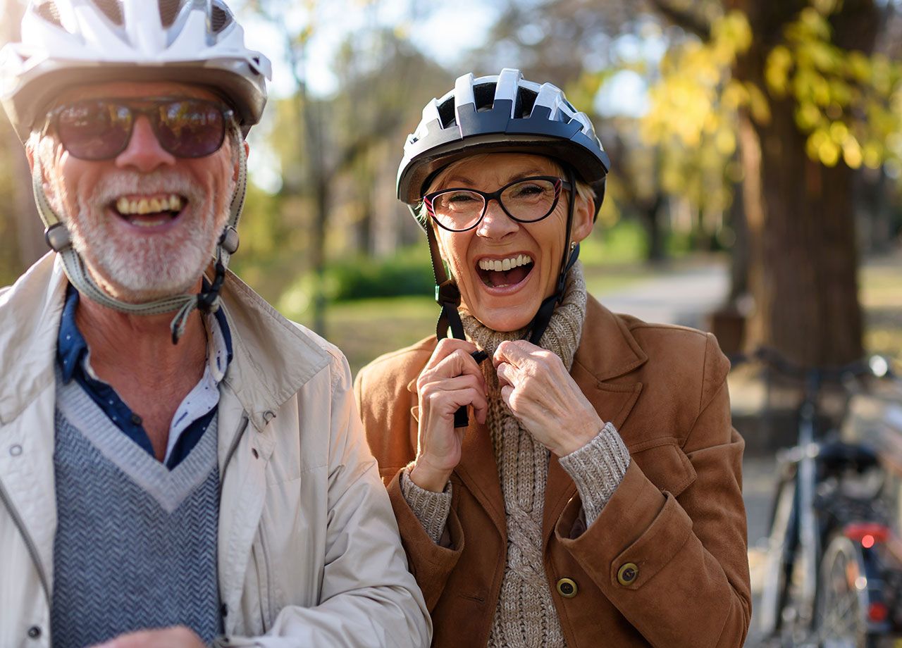 Man and woman wearing bike helmets