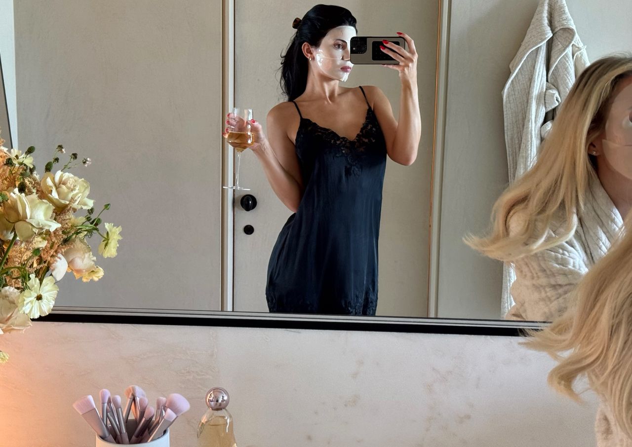 Kylie Jenner black slip dress face mask selfie
