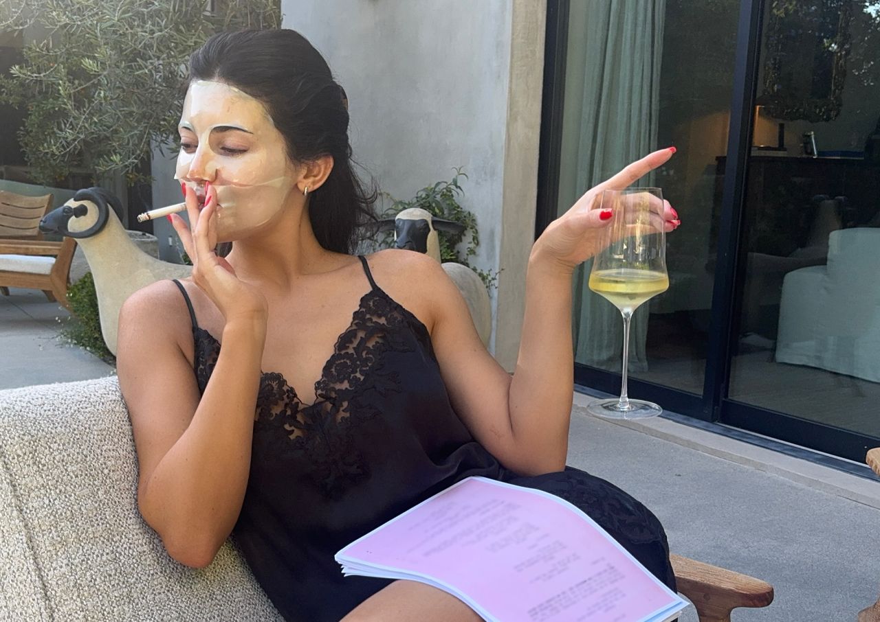 Kylie Jenner black slip dress smoking