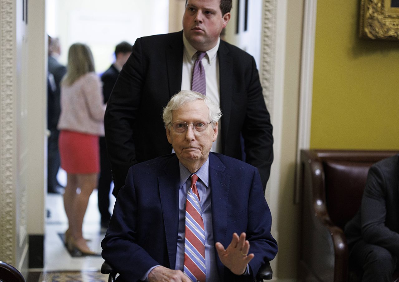 Mitch McConnell departs a meeting