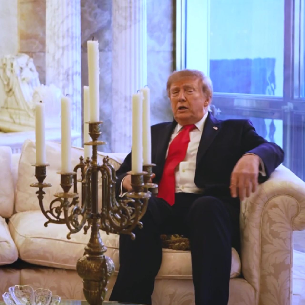 Donald Trump sitting on a pillow at Trump Tower