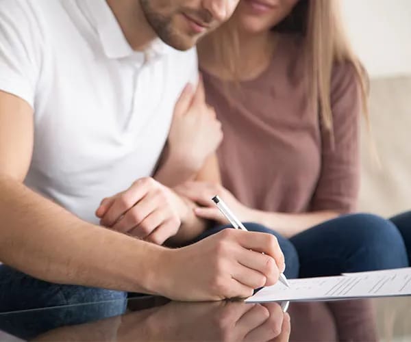 couple signing papers