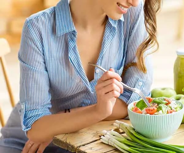 4. Eat With No Distractions woman eating salad