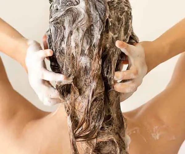 Washing Too Often woman washing hair