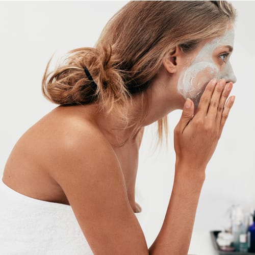 woman applying face mask