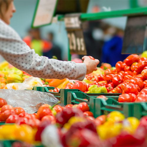A person shopping for produce.