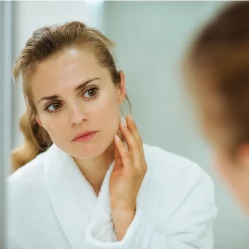 woman looking in mirror