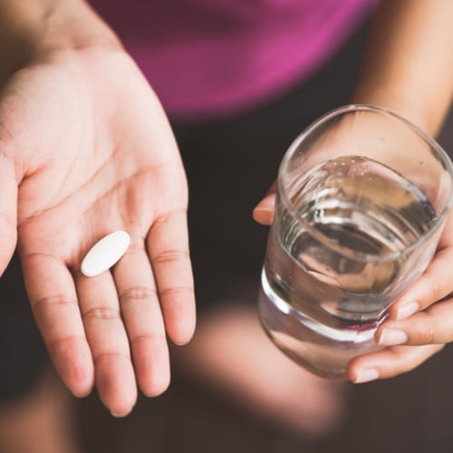 woman taking pill