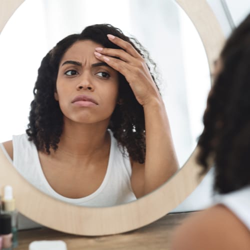 woman looking in mirror