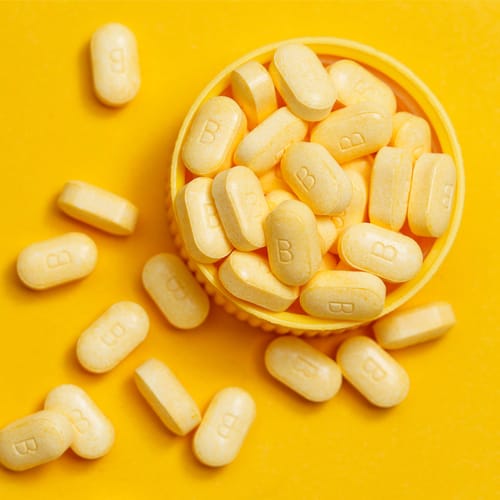 Vitamin B on a yellow background.