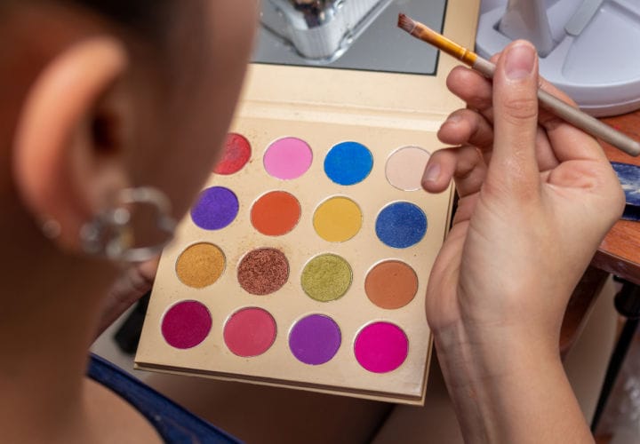 Woman applying eye shadow.