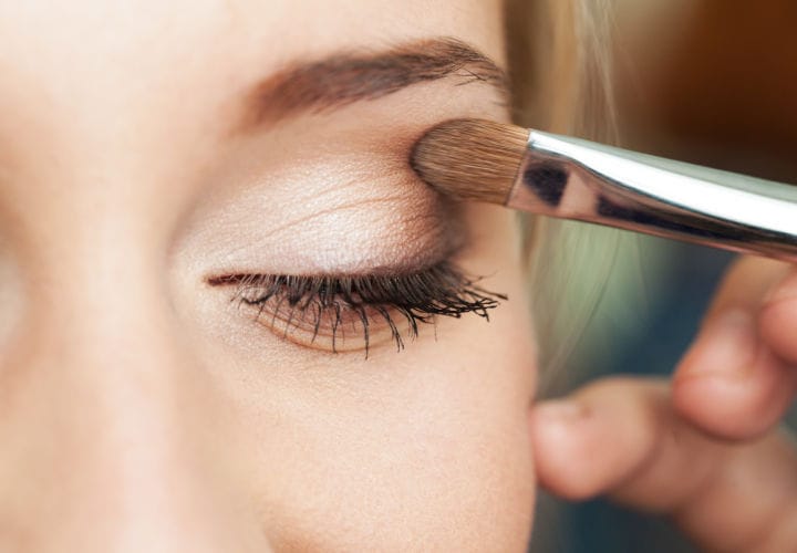 Woman applying eye shadow.