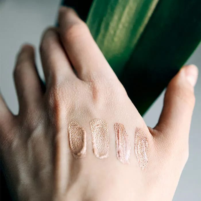 Makeup swatches on a woman's hand.