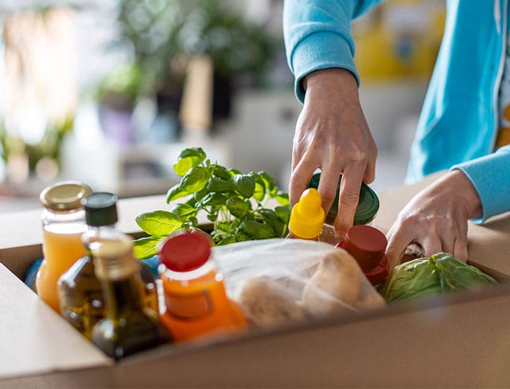 Woman unpacking a grocery delivery order