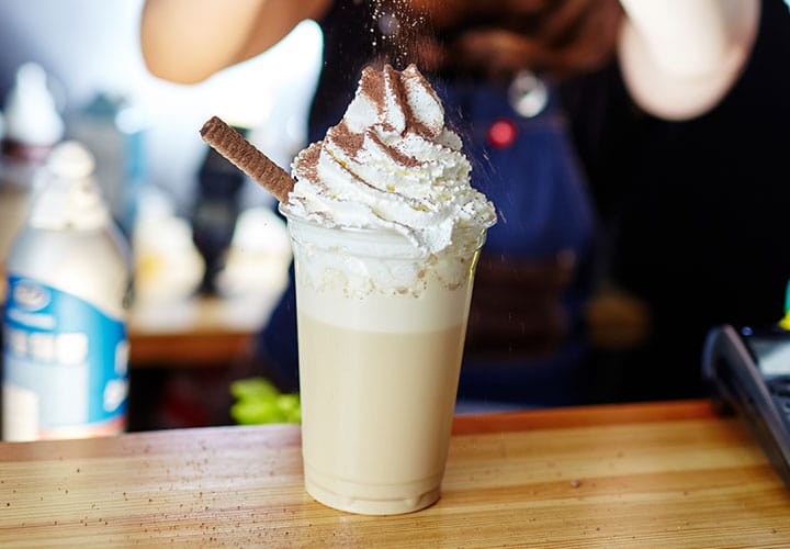 Barista making a frozen coffee.