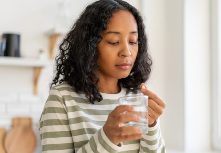 Woman holding a supplement