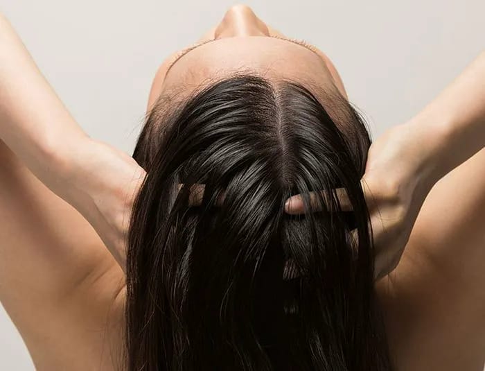 Woman massaging hair.