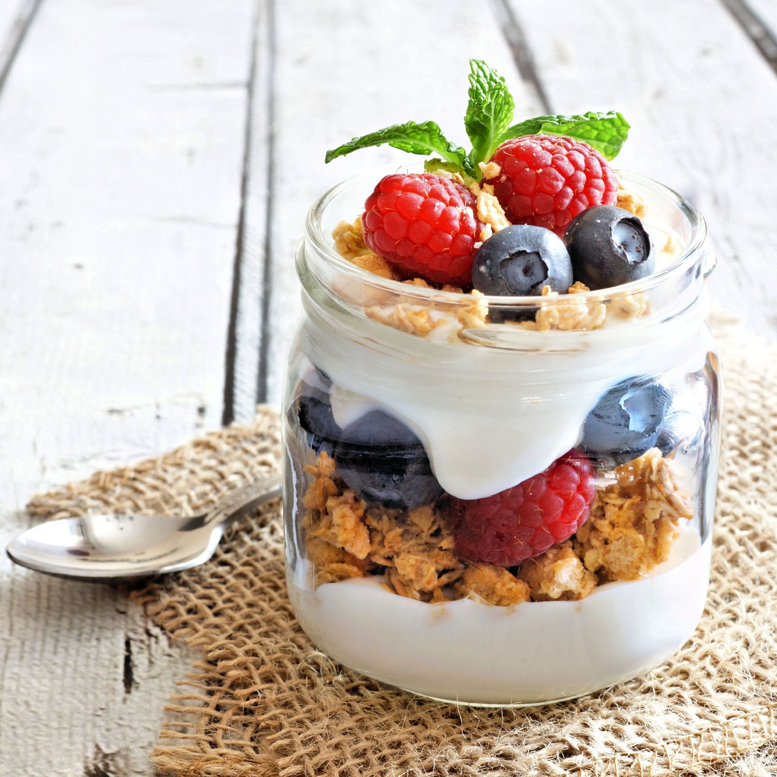 yogurt parfait with granola and berries in a jar