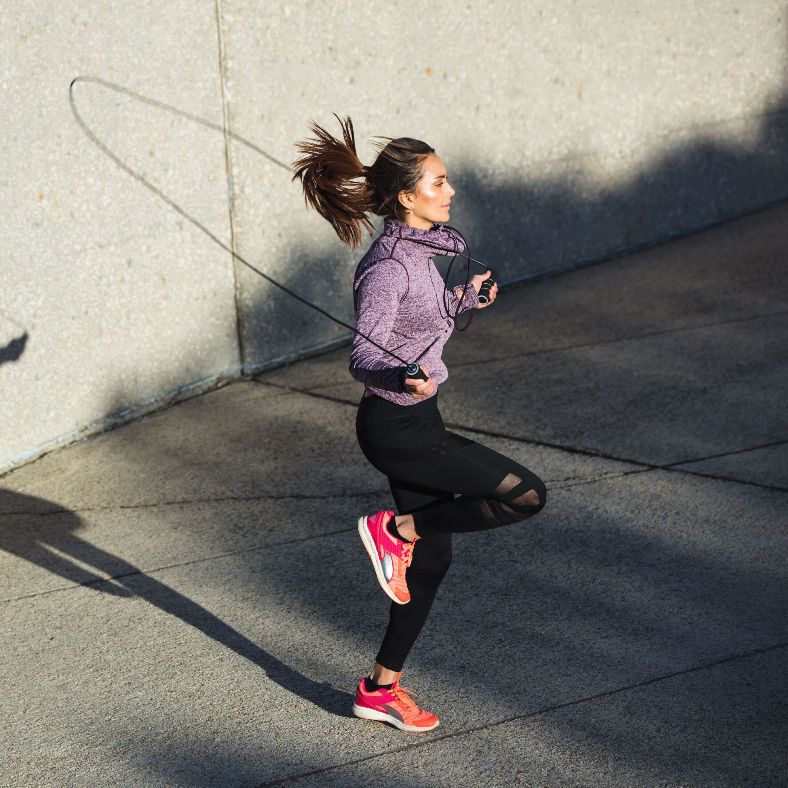 woman jumping rope outside
