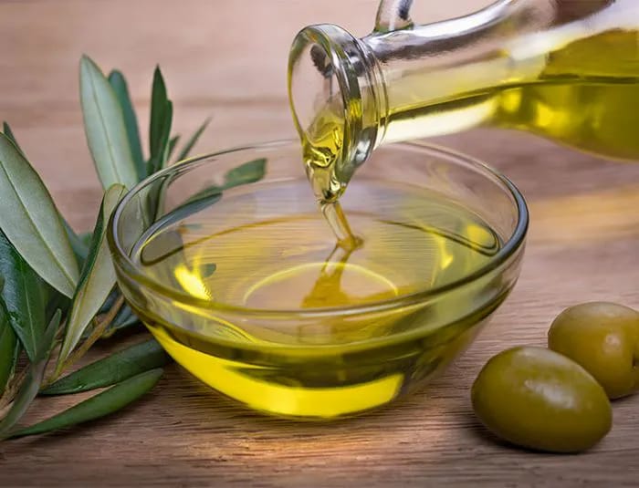 Pouring olive oil into a bowl