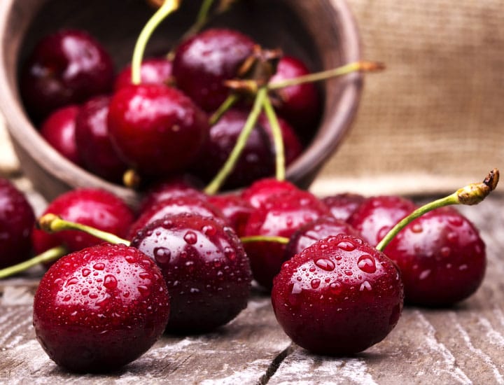 Cherries with water droplets on table