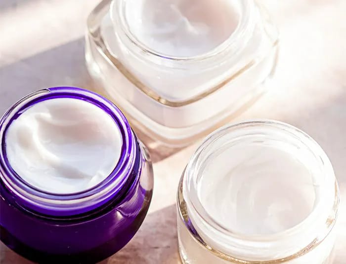 two clear one purple jar of moisturizing white cosmetic skincare cream