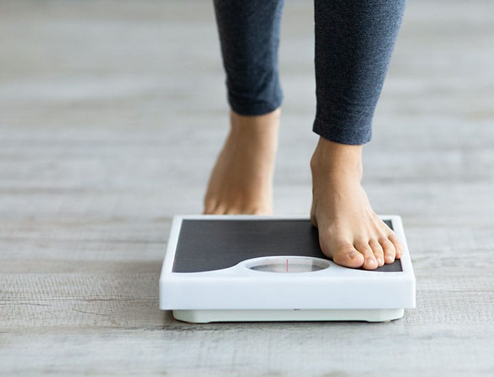 Woman stepping on a scale