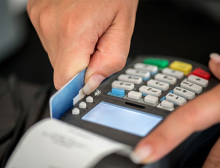 Hand swiping credit card