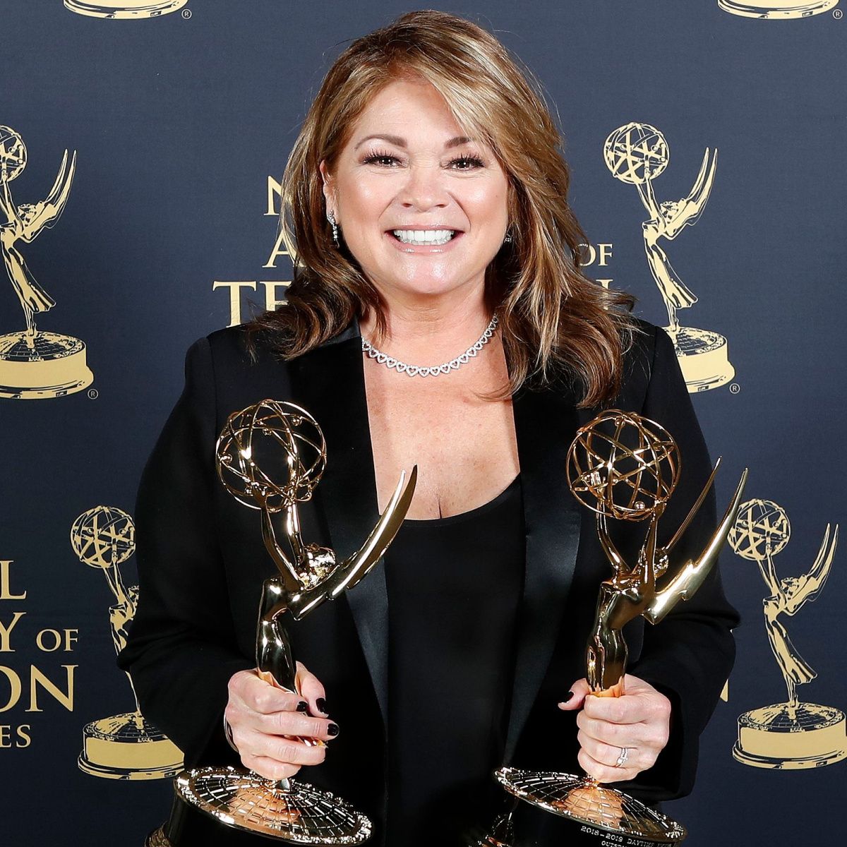 valerie bertinelli holding award trophies red carpet
